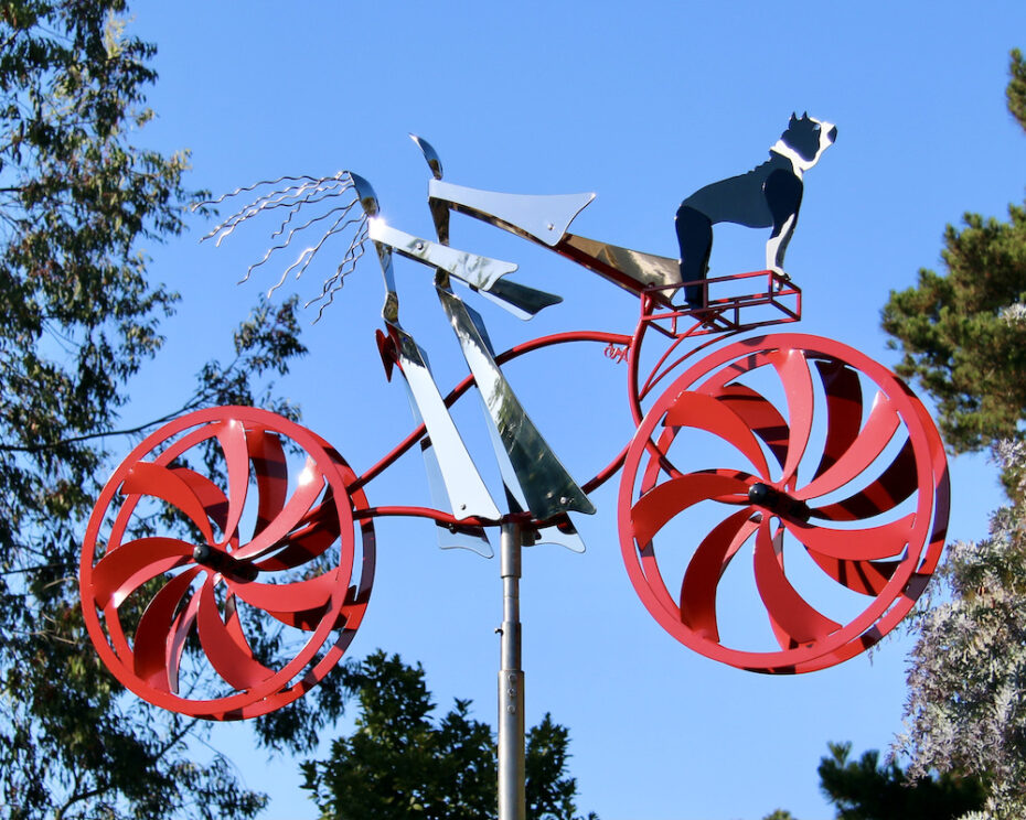 Kinetic bicycle sculpture by Amos Robinson male cyclist female cyclist dog stainless steel contemporary art